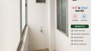 A bathroom with a hot and cold water heater mounted on the wall, a window, and a vent.