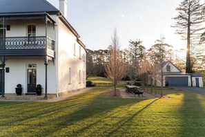 A two-story house with a balcony, a lawn, and a garage. - 'Glenworth House' - Heritage Berry Mountain Estate (Berry Mountain)