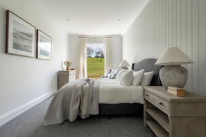 A bedroom with a bed, bedside tables, a lamp, and a window with curtains. - 'The Cottage' at Glenworth Estate (Berry Mountain)