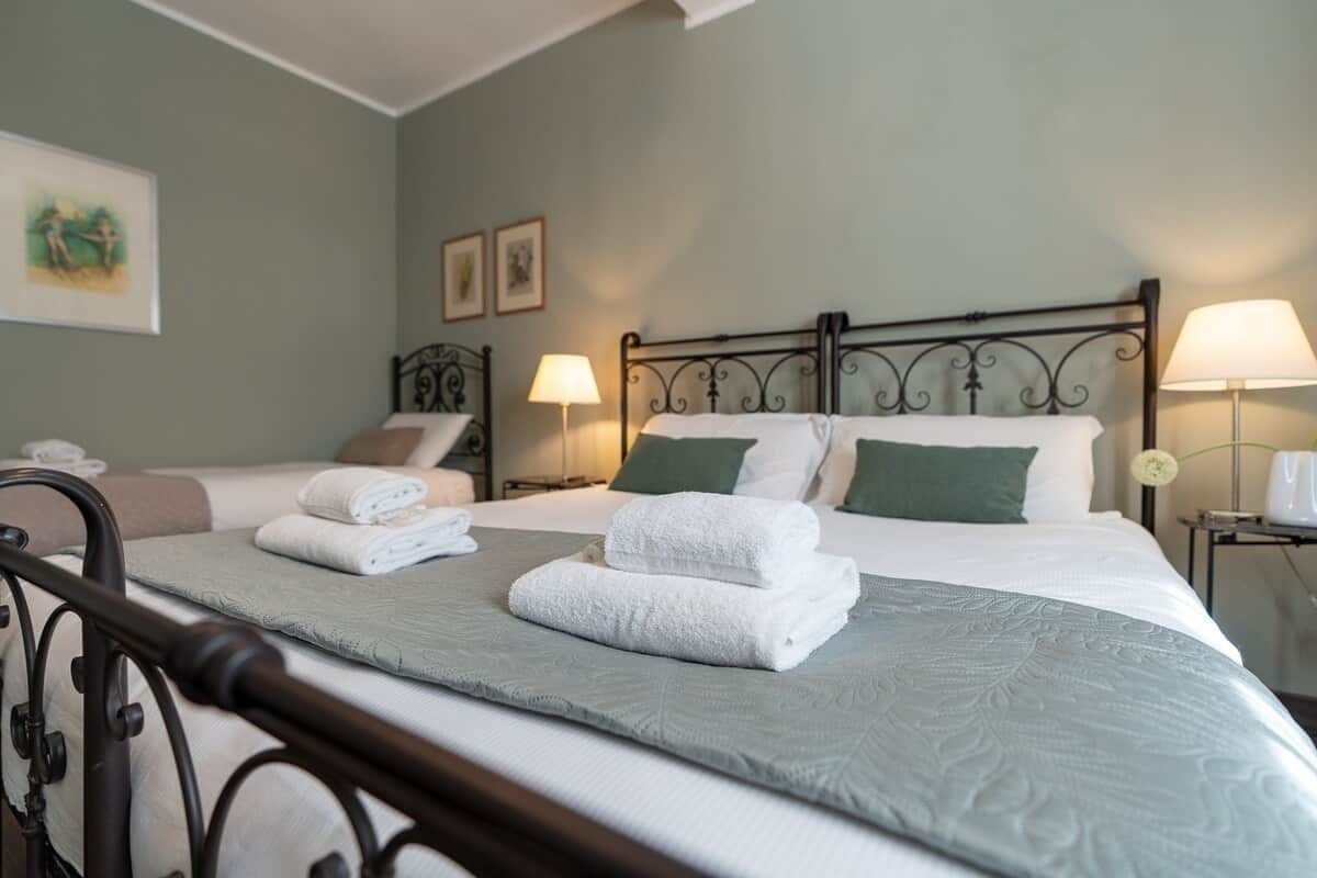 Ein Hotelzimmer mit einem Bett, zwei Nachttischen und einem Beistelltisch.