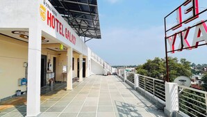 A hotel with a solar panel roof, a covered walkway, and a satellite dish.