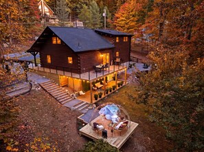 A log cabin with a deck, outdoor seating, and a swimming pool. - Luxury 4BR Mountain Cabin for 8 - Stargazing Dome, Hot Tub & Game Lounge (Harpers Ferry)