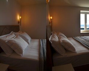A room with two beds, each with white bedding and pillows, and a window with a view. - Holiday Home 'Vacation House Martin' with Sea View, Wi-Fi and Air Conditioning (Grižane-Belgrad)