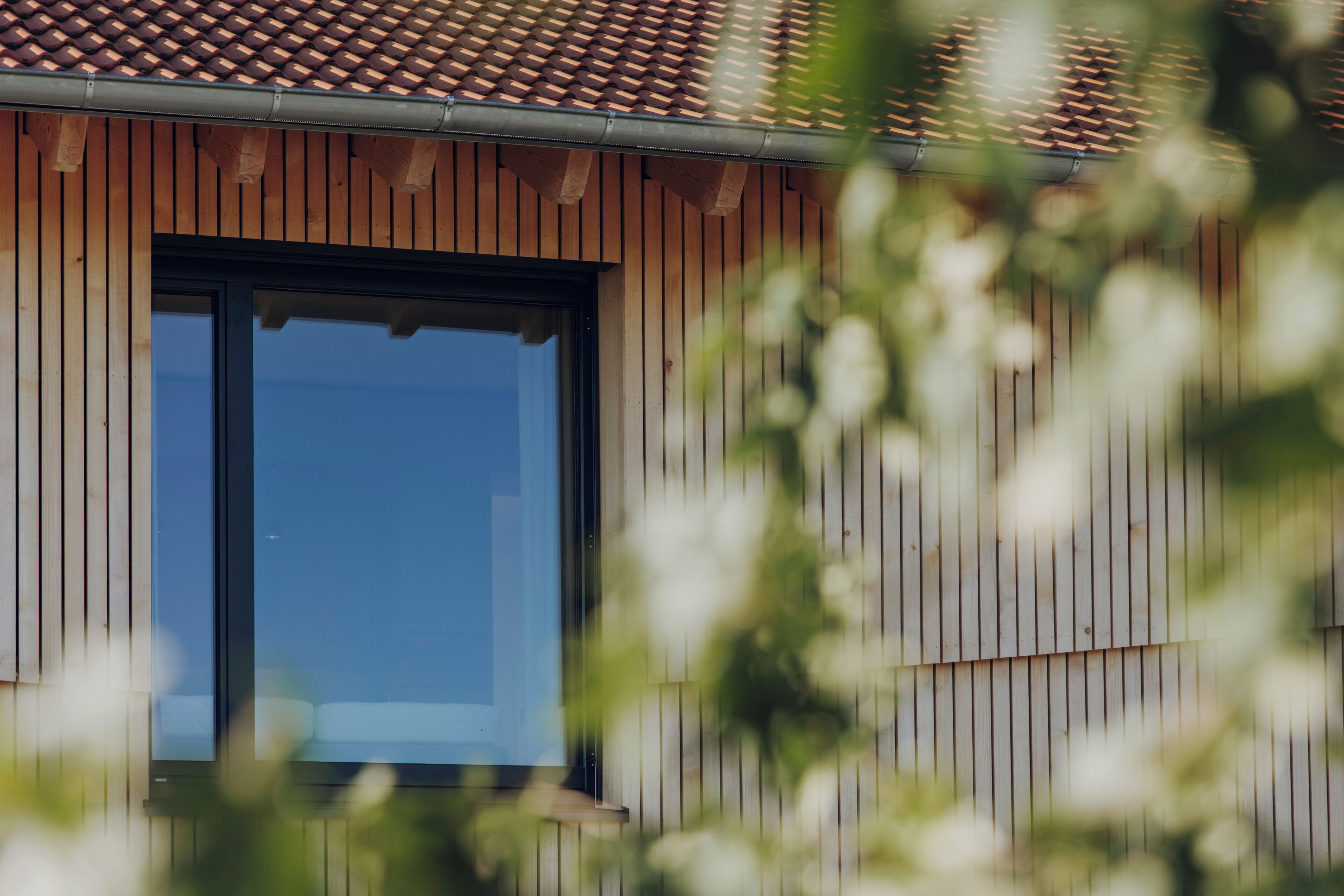 A building with a wooden facade and a large window.