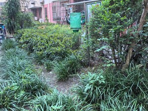 A garden area with various plants and a green structure, possibly a water feature or a decorative element. - Innocondo Extended Stay Changning  West Yan'an Road (Shanghai)