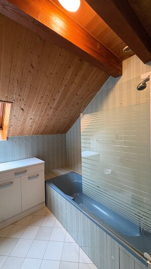 A modern bathroom with a wooden ceiling, a glass bathtub, and a white vanity. - Apartment 'Logement Entier 8 Couchages Wifi' with Mountain View and Wi-Fi (Saint François Longchamp)