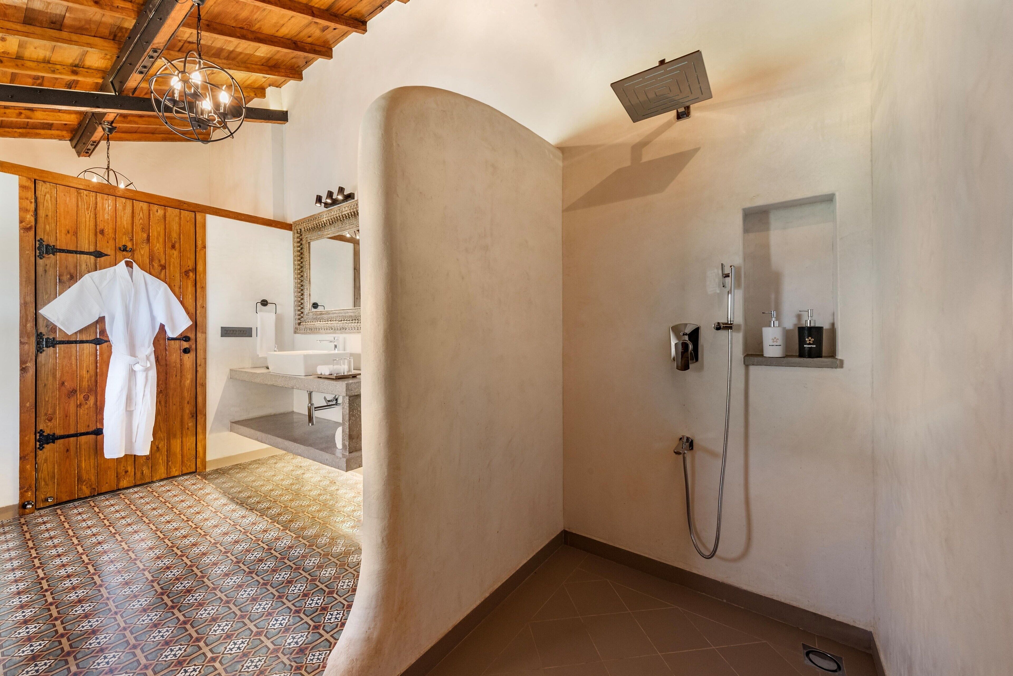 A bathroom with a shower, a sink, and a mirror.