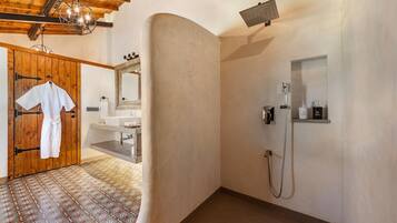 A bathroom with a shower, a sink, and a mirror.