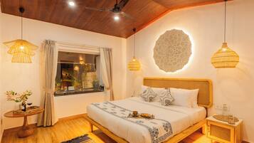 A bedroom with a wooden bed, a ceiling fan, and two bedside lamps.