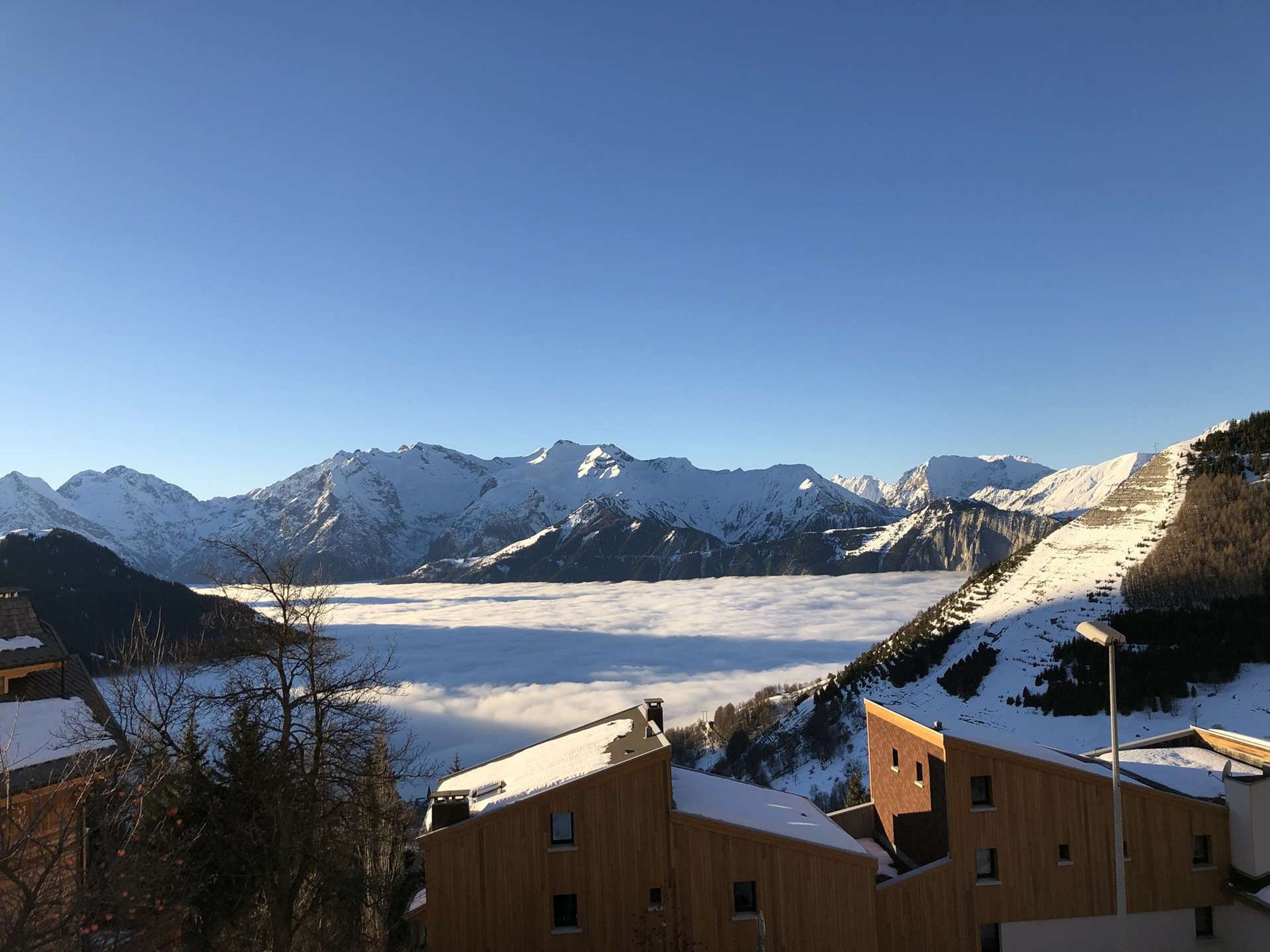 A mountain landscape with snow-covered peaks and a valley.