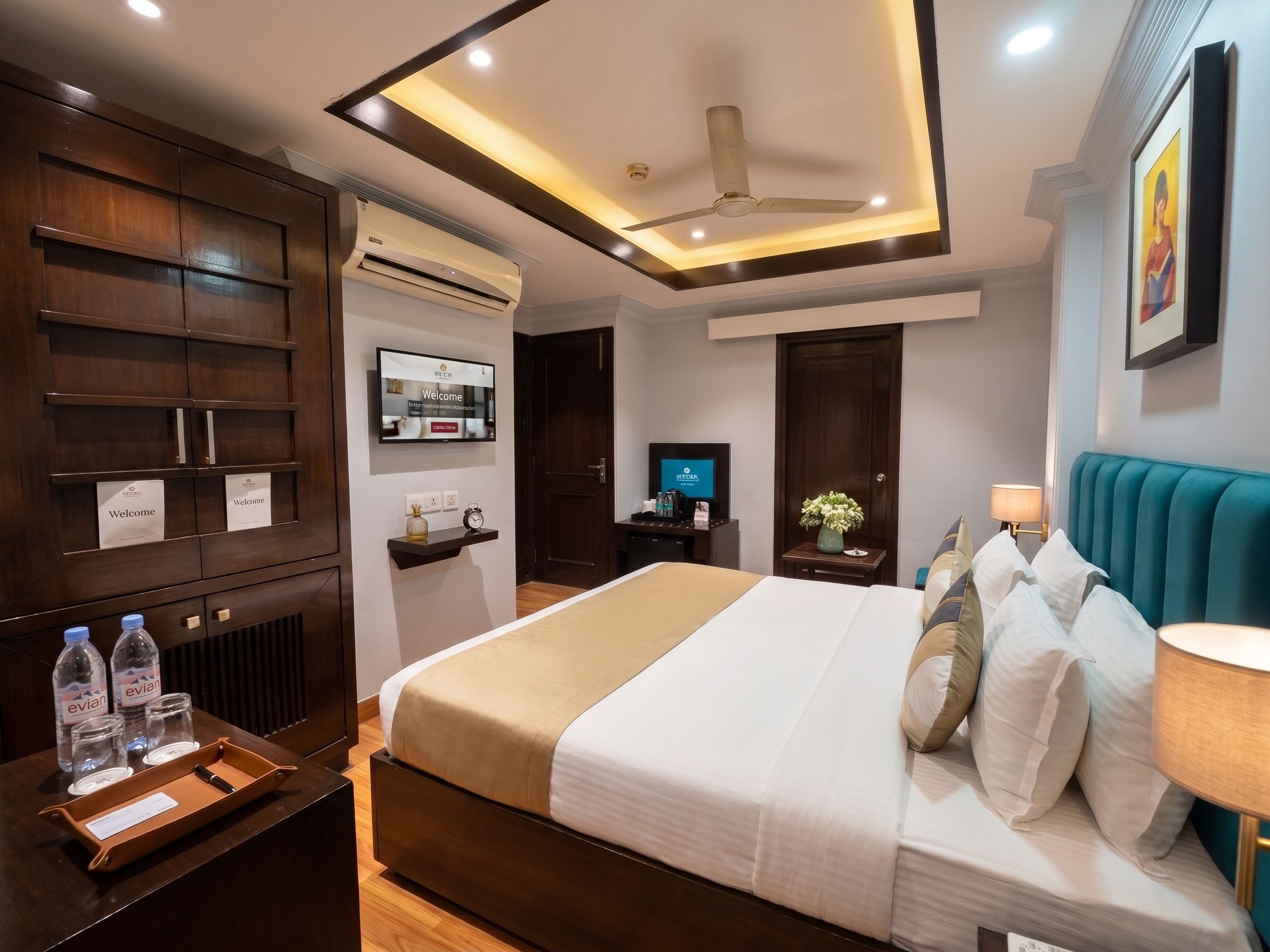 A hotel room with a bed, bedside table, TV, and a ceiling fan.