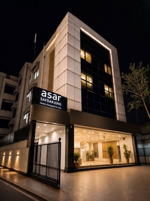 A modern hotel facade with a prominent sign for 'asar SAFDARJUNG Hotels Designed for You' at night. - asar Safdarjung By Orion Hotels (New Delhi)