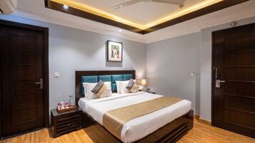 A hotel room with a bed, bedside table, and a ceiling fan.