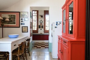 A kitchen with a red cabinet, a white countertop, and a checkered floor. - Villino alla Croce by Wonderful Italy (Ostuni)