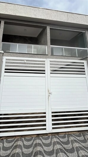 A building with a garage door and a window above it.