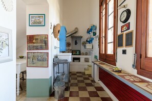 A kitchen with a checkered floor, a sink, and various kitchen utensils. - Villino Alla Croce by Wonderful Italy (Ostuni)
