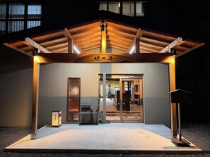 A building with a wooden roof and a sign above the entrance.
