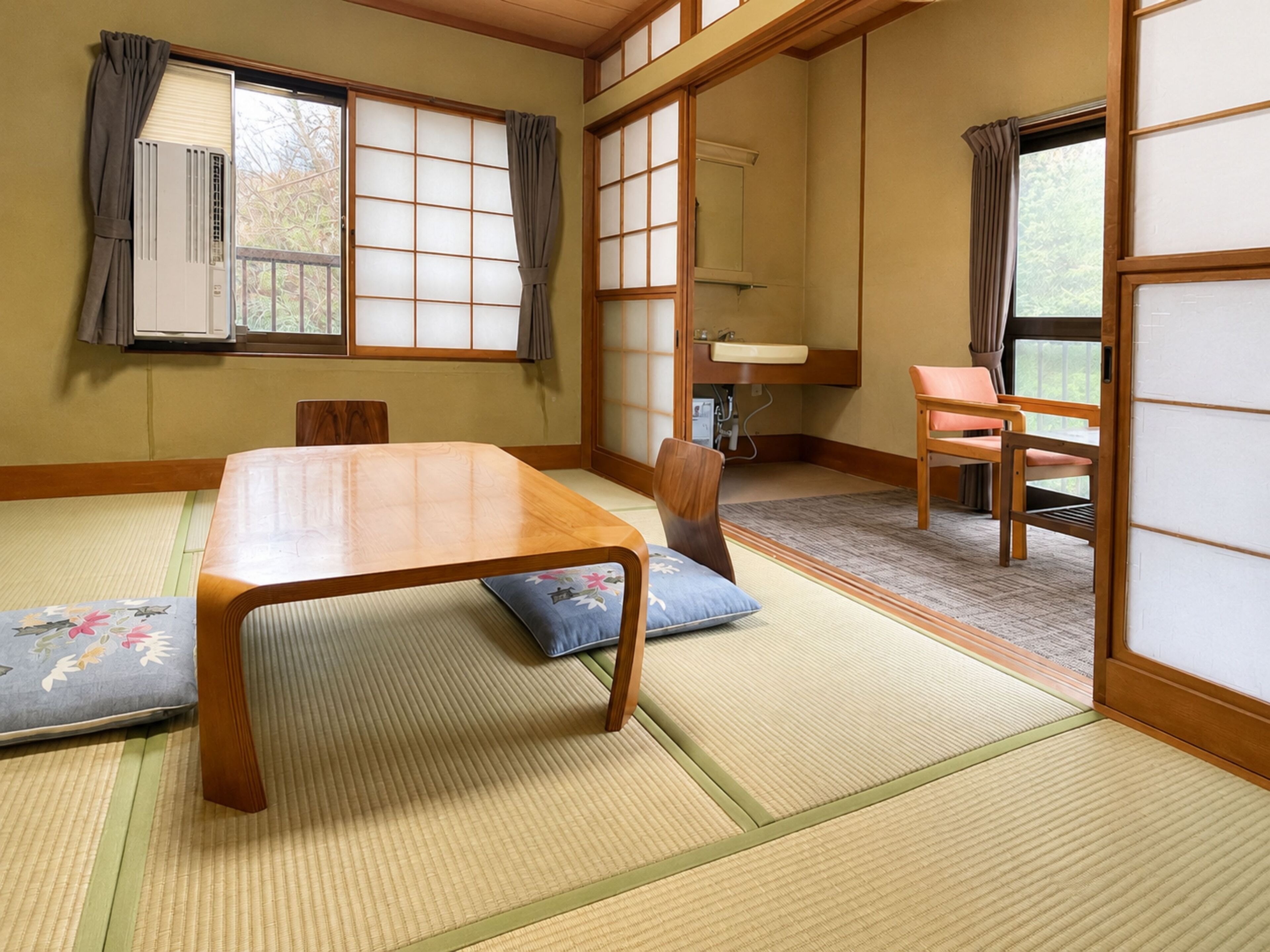 Een traditionele Japanse kamer met tatami vloerbedekking, een lage houten tafel en schuifdeuren van shoji.