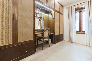 A room with a wooden desk, a chair, and a large mirror. There is a window with curtains and a wooden door. - Lily Hidden Homestay Spacious 150m² 2BR near Hoan Kiem Lake (Hanoi, Vietnam)