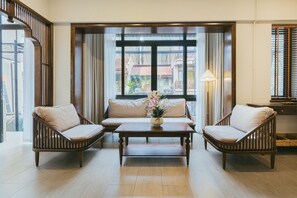 A spacious living area with a sofa set, two armchairs, and a coffee table. - Lily Hidden Homestay Spacious 150m² 2BR near Hoan Kiem Lake (Hanoi, Vietnam)