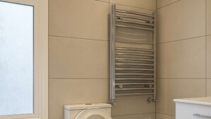 Ein modernes Badezimmer mit Toilette, Bidet, Mülleimer und Handtuchhalter.