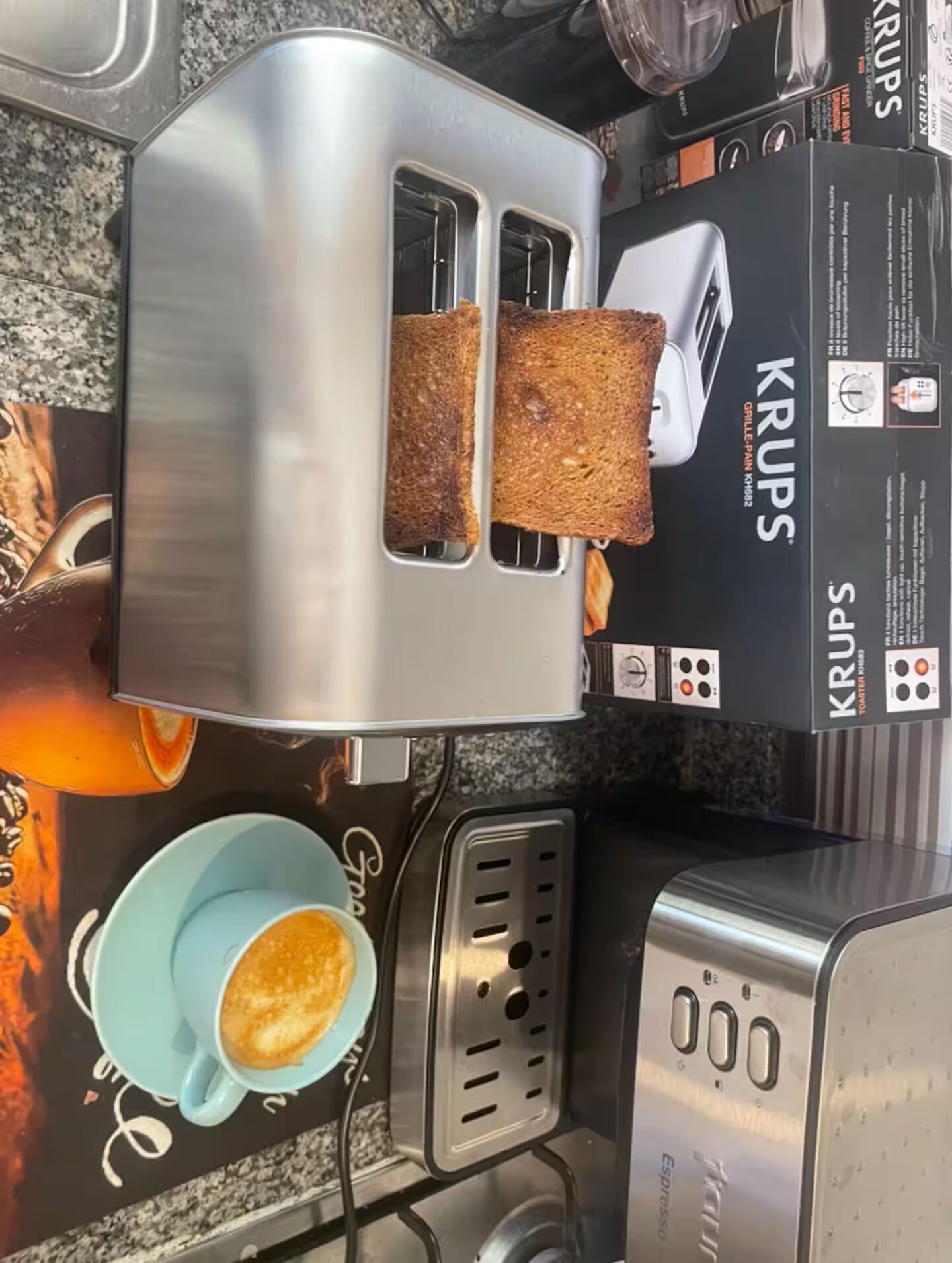 A kitchen with a toaster and a coffee maker.