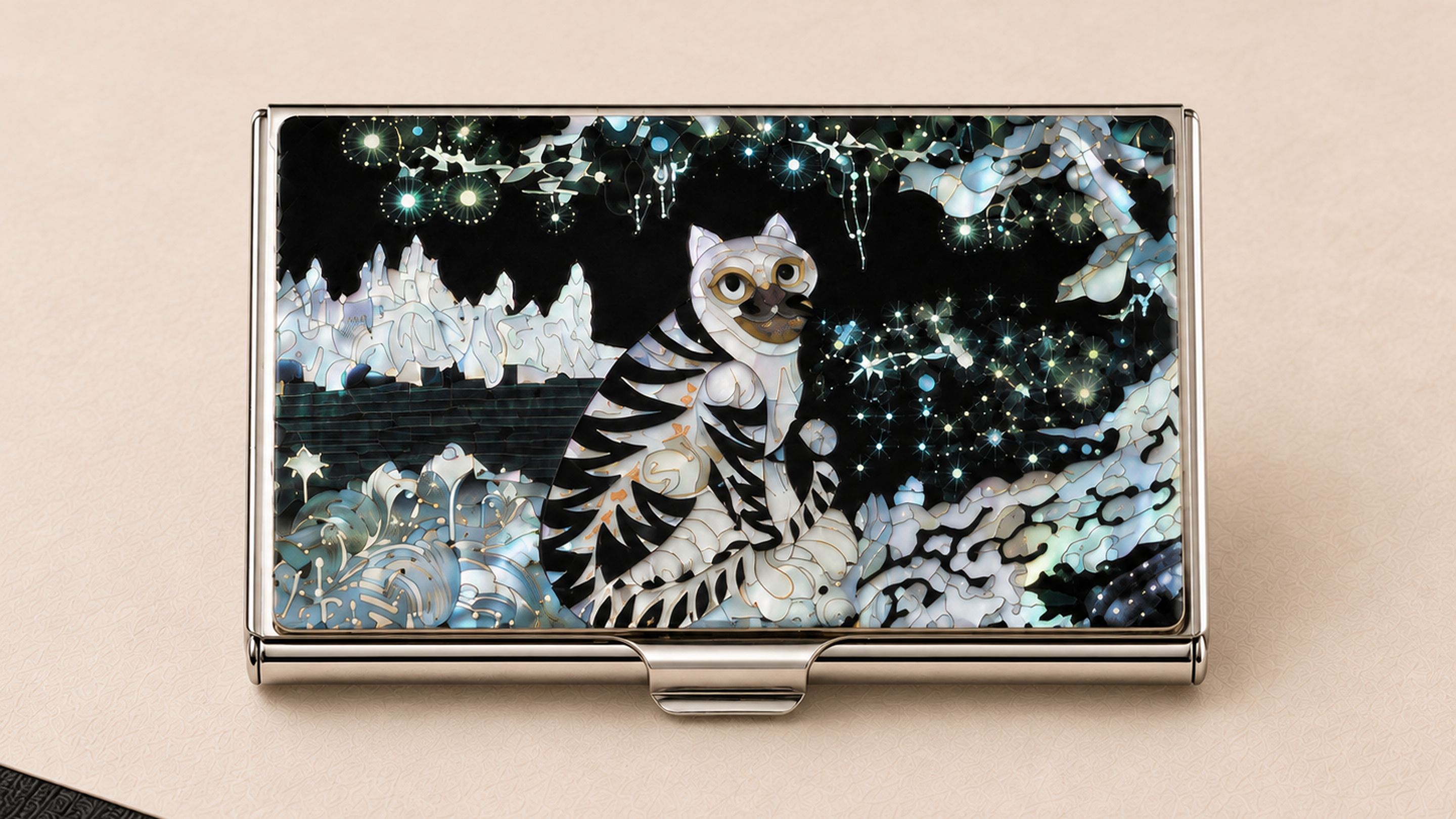 A metallic object with a reflective surface and a central design featuring a stylized animal and abstract patterns.
