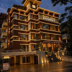 Un edificio de varios pisos con un letrero que dice 'PACIFY HILLS RESIDENCY'.