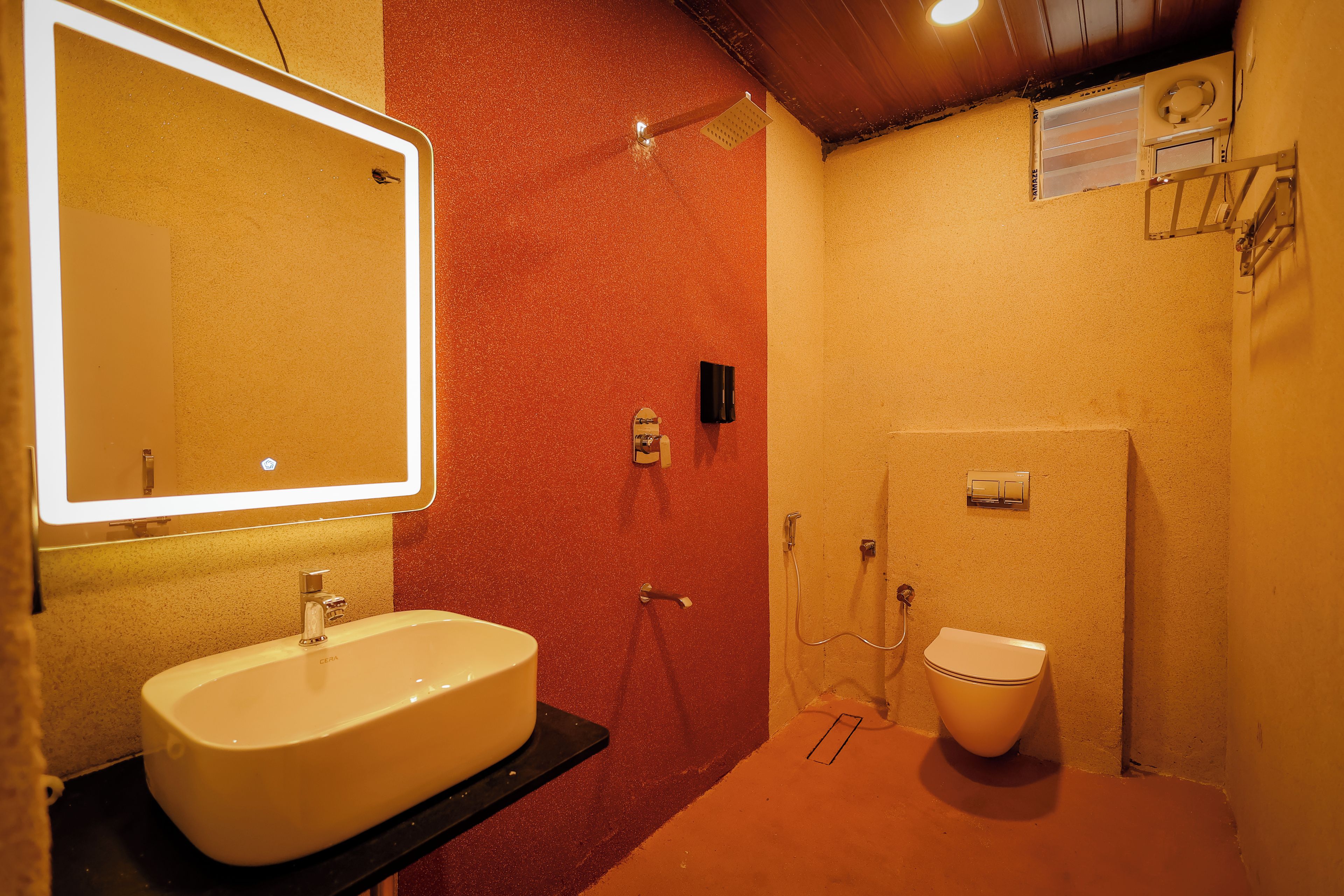 A bathroom with a sink, mirror, shower, and toilet.