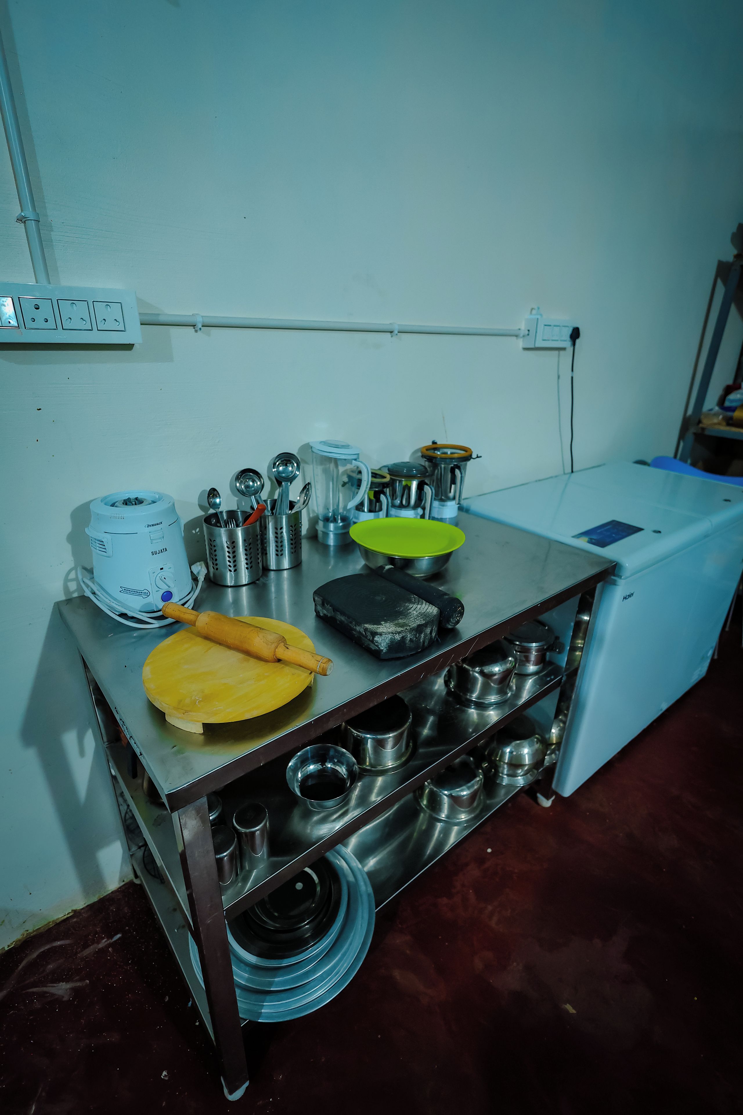 A kitchen counter with various utensils and appliances.
