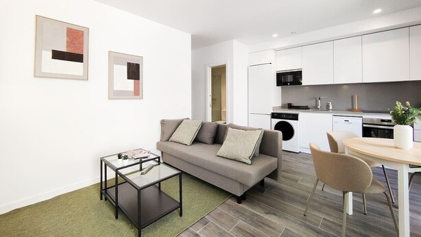 A modern apartment with a living area, kitchenette, and a dining space. - Modern Home in Vicálvaro (Madrid)