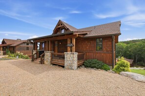 A wooden lodge with a stone entrance, a covered porch, and a gravel driveway. - Peak a View  - Lux Cabin w Tri-State VIEWS at 4,200 Feet! (Beech Mountain)