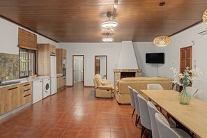 A modern kitchen with wooden cabinets, a built-in oven, and a large window. - Country House 'Rural La Armona' with Private Garden, Wi-Fi and Air Conditioning (La Carlota)