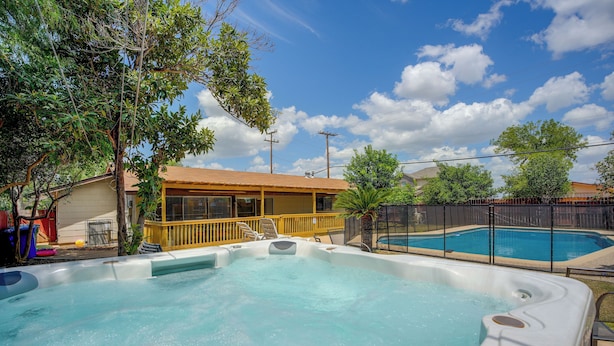 A backyard with a hot tub, a swimming pool, and a wooden deck. - The Airman House Pool-hot Tub-fun by Lackland AFB (San Antonio)