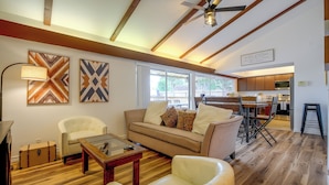 A modern living room with a sofa, armchairs, a coffee table, and a ceiling fan. - The Airman House Pool-hot Tub-fun by Lackland AFB (San Antonio)
