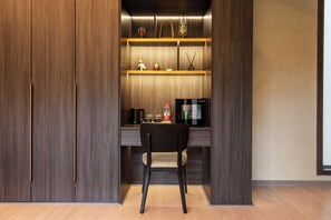 A compact kitchenette with a coffee maker, microwave, and storage shelves. - Sun Valley Resort (Zhangjiajie)