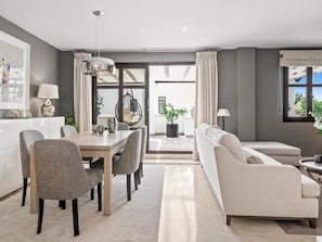 A modern living room with a dining area, a sofa, and a hanging chair. - Privilegio Marbella (Marbella)