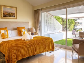 A hotel room with a bed, a nightstand, a lamp, a painting, and a view of the outdoors. - Penthouse Boutique Suite Marbella (Marbella)