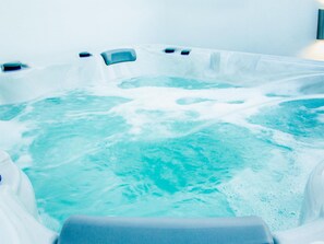 A hot tub with visible water jets and a seating area. - Calle Pintado 21 Atico (Estepona)