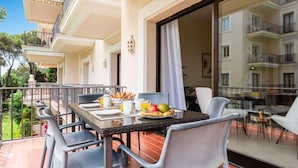 A dining area with a table set for two, chairs, and a buffet with food and drinks. - Gran Terraza ref ADM 116 (Marbella)