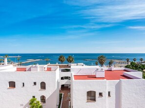 A coastal building with white walls and red roofs, overlooking a beach and the sea. - Br Playas Del Duque Ref C412 (Marbella)