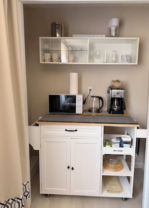 A kitchenette with a microwave, coffee maker, and storage cabinets. - Private & Serene Stay 2-bedroom studio - Osterville - AC - Free Beach Pass - W/D (Barnstable)