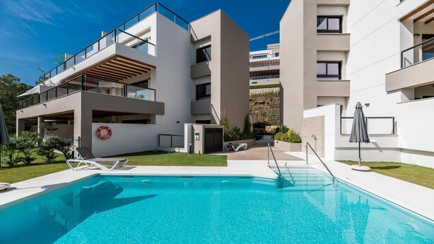 A modern building with a swimming pool, outdoor seating, and a lifebuoy decoration. - Endless Luxury At Marbella Lake Paradise (Marbella)