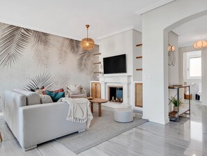 A modern living room with a sofa, a fireplace, and a television. - Precioso Tico con Vistas al mar ref 771 (Marbella)