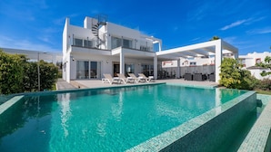 A modern two-story house with a swimming pool, outdoor seating, and a spiral staircase. - Villapadierna Solstice Sanctuary Villa (Estepona)