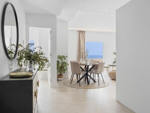 A modern dining area with a round table, chairs, and a view of the sea. - Andalucia del Mar 14 61 (Marbella)