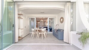 A modern interior with a dining area, a sofa, and a kitchen in the background. - Sol de Mijas in Marbella (Mijas)