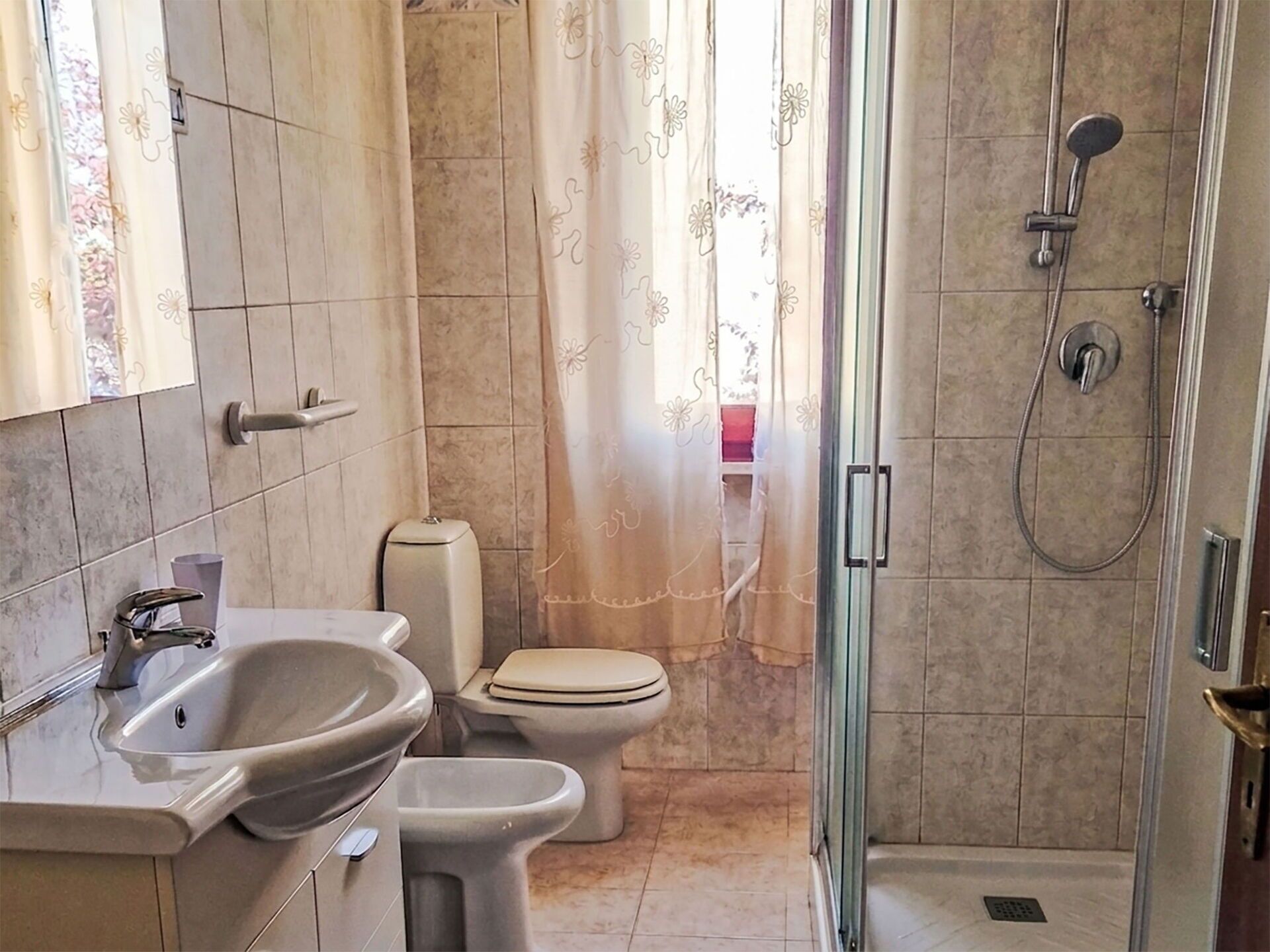 A bathroom with a sink, toilet, and shower.