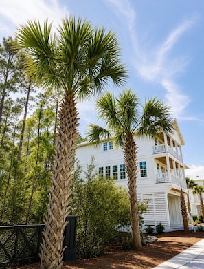 A two-story building with a white exterior, multiple windows, and a balcony on the upper floor. - Escape to Paradise along the Emerald Coast (Rosemary Beach)