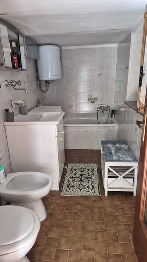 Een douche, een bidet, zeep, toiletpapier